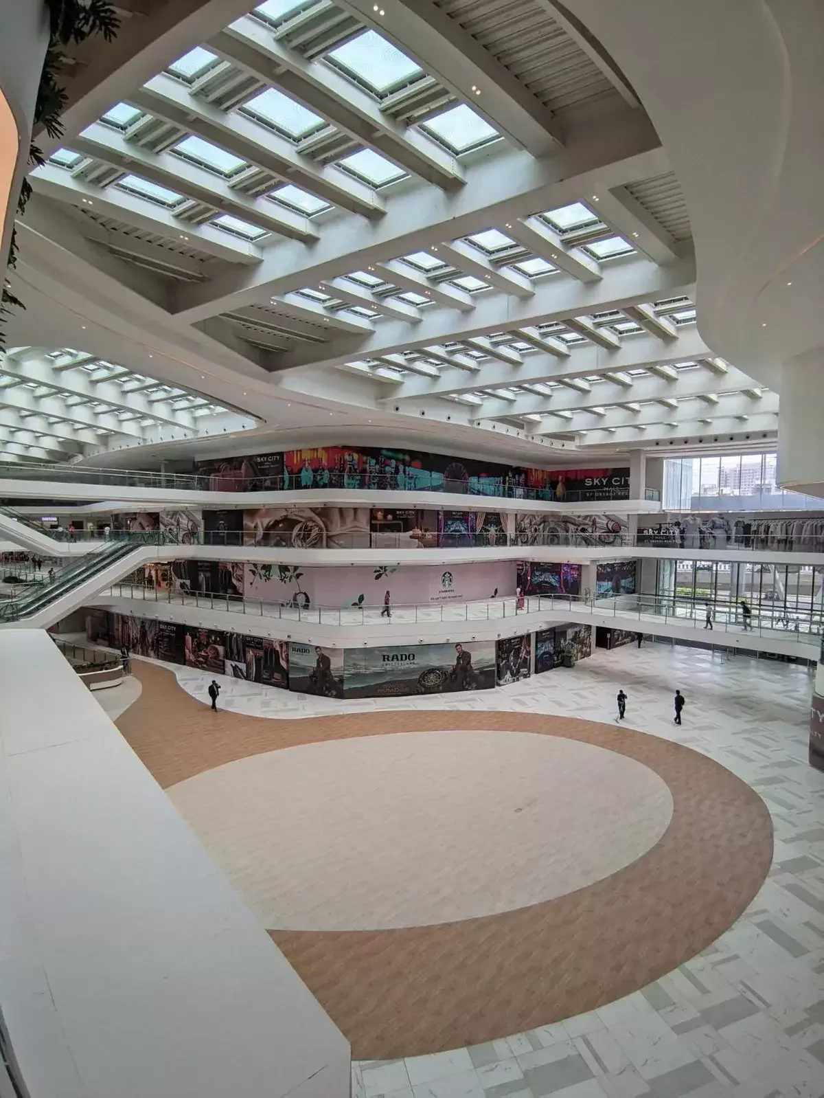 Commercial architectural roofing at Oberoi Mall, Mumbai: Specialized Kliplok roof-on-roof installation by Rishonn & Reyansh for leak-proof retail infrastructure.
